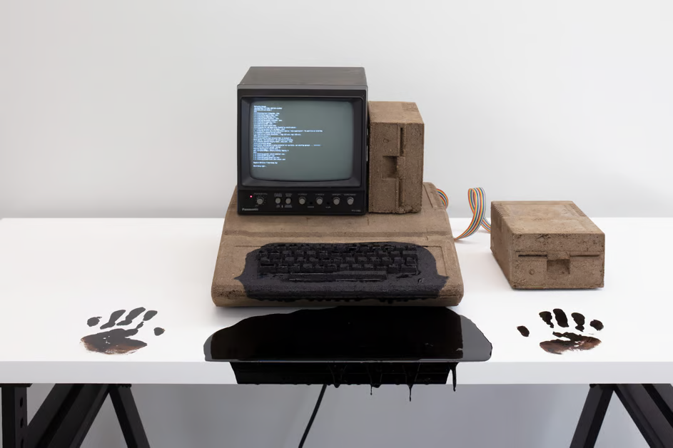 artwork: American Artist / Mother of All Demos II, 2021. Dirt, monochome CRT monitor, computer parts, Linux operating system, subwoofer cable, wood, asphalt. 149.9 x 74.9 x 127 cm. Photography by: Ramiro Chaves. Courtesy of American Artist and Labor. from https://www.collecteurs.com/interview/american-artist-black-gooey-universe
